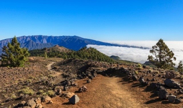 Volcanic mountain peak above the clouds in La Palma, Canaries, Spain
