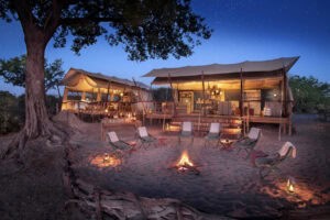 A scenic Botswana safari camp with a cozy campfire setting