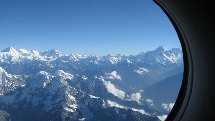 A breathtaking aerial view of the Himalayas, showcasing the scenic Kathmandu to Lhasa flight route.
