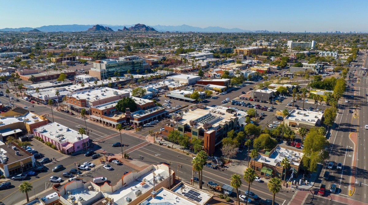 An aerial shot of Phoenix/Scottsdale, Arizona, showcasing low-rise buildings and greenery.