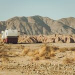 Travel trailer boondocking in the desert offering free RV camping with stunning desert landscapes