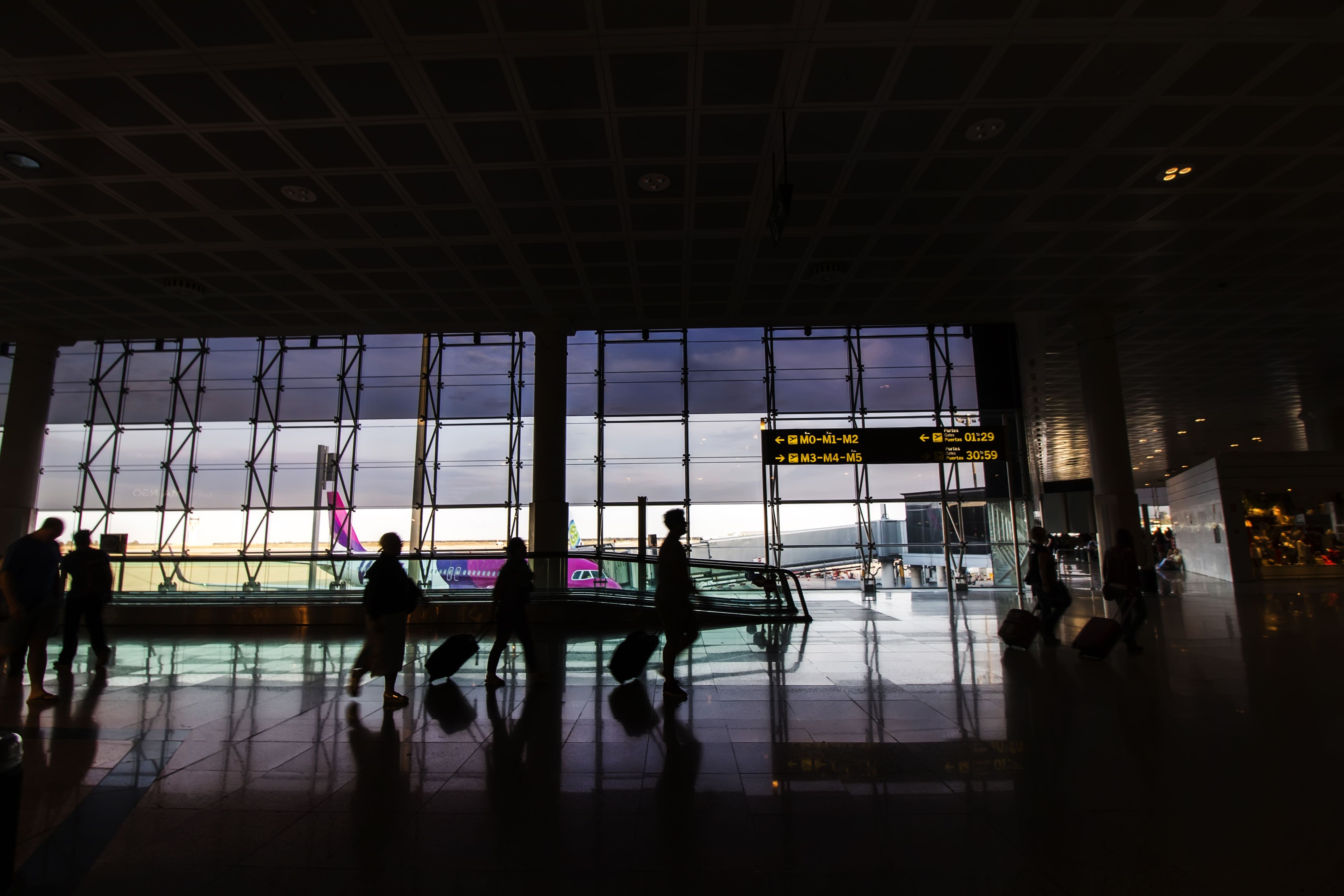 An airport terminal with people walking, representing the expanded travel possibilities through interline agreements.