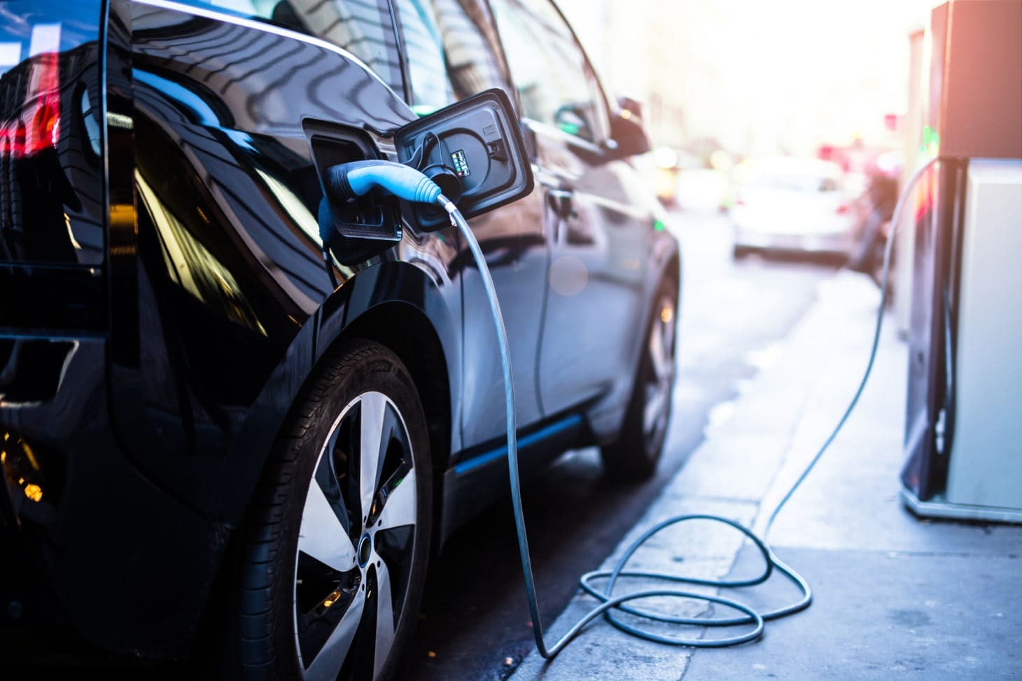 Electric SUV charging at a station