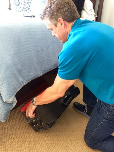 Storing luggage under the bed with protective cover