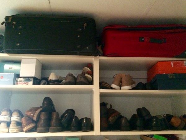 Suitcase storage shelves in a closet
