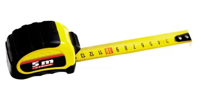 Person measuring the height of a travel trailer using a measuring tape