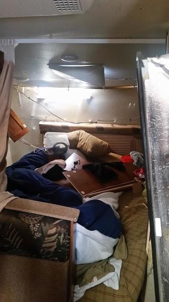 Damaged travel trailer after an accident, emphasizing the importance of safe towing practices