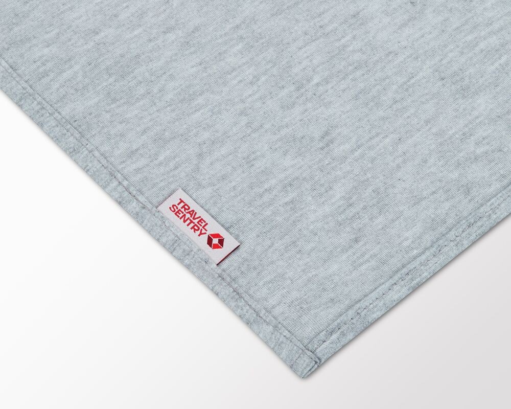Travel Blanket Alt Text: A TRAVELS.EDU.VN travel blanket, showcasing its cozy texture and compact size for comfortable travel.