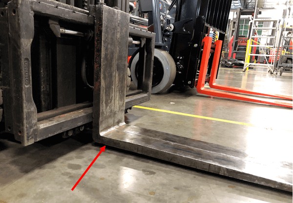 Worn forklift forks showing the effects of dragging