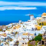 Traditional white homes on hillside overlooking Aegean Sea in Santorini, Greece