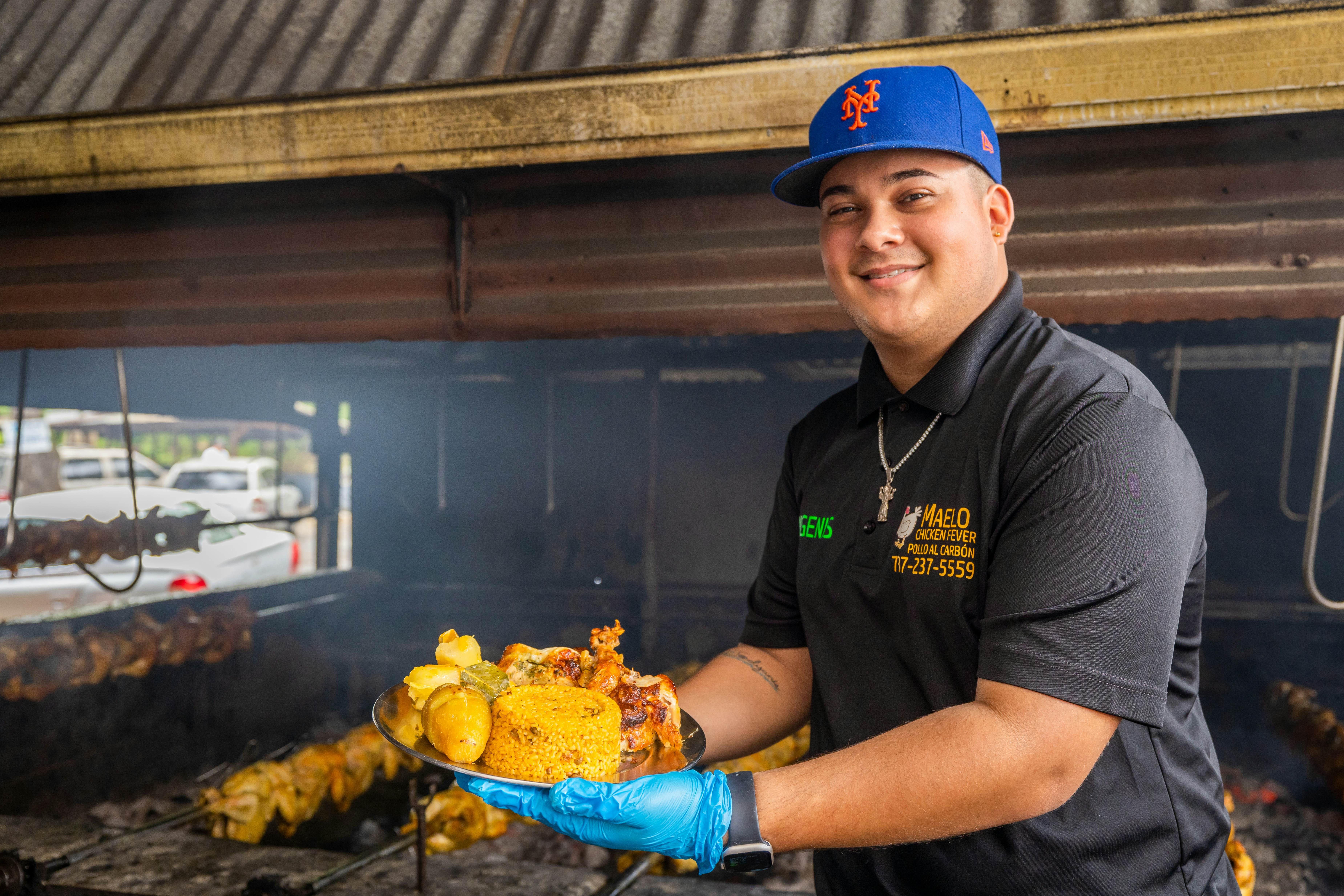 Man holding a plate of delicious Puerto Rican food