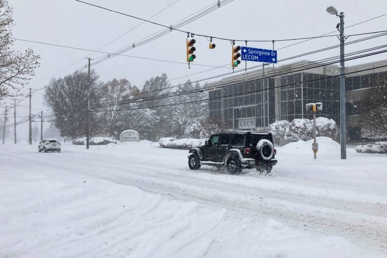 Jeep driving on snowy road in Erie, PA