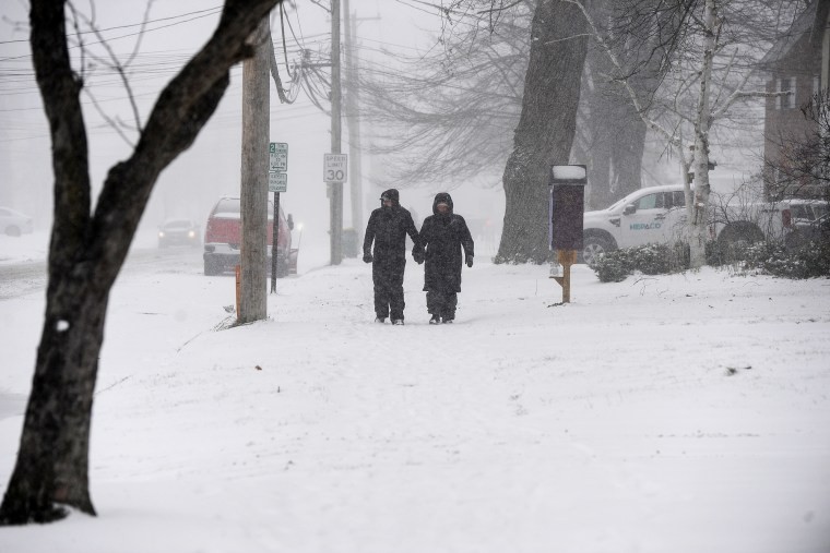 Couple walking in lake effect snow in Hamburg, NY