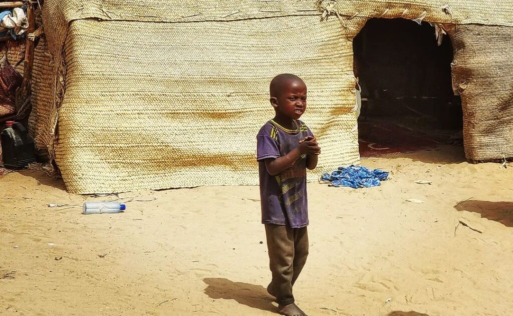 Local life in Timbuktu, with children and traditional architecture providing a glimpse into the cultural richness and everyday routines of the city.