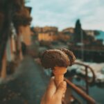 Scenic Italian street with a Vespa parked in front of a local trattoria, showcasing the charm of budget-friendly travel in Italy