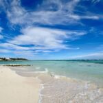 Scenic view of Playa Blanca, Punta Cana, with clear turquoise waters meeting the pristine white sand beach