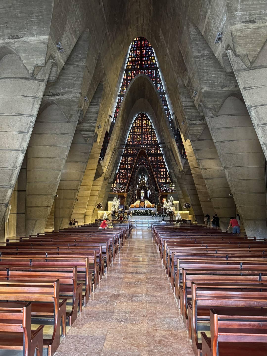 Inside the Basilica Nuestra Señora De La Altagracia, showcasing a spacious interior with wooden pews