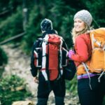 Woman wearing a backpack, demonstrating how to travel internationally while backpacking
