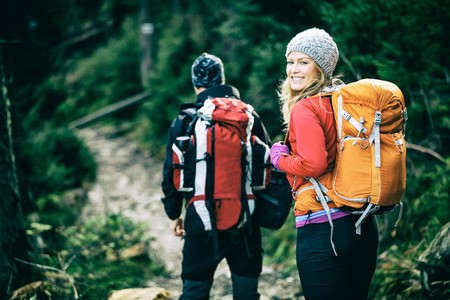 Woman wearing a backpack, demonstrating how to travel internationally while backpacking