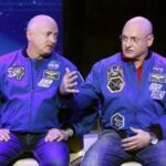 Astronaut Scott Kelly in his blue NASA flight suit, showcasing the real-world effects of time dilation during space travel