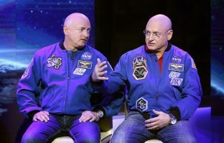 Astronaut Scott Kelly in his blue NASA flight suit, showcasing the real-world effects of time dilation during space travel