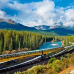 train curving near Lake Louise on bright, sunny day