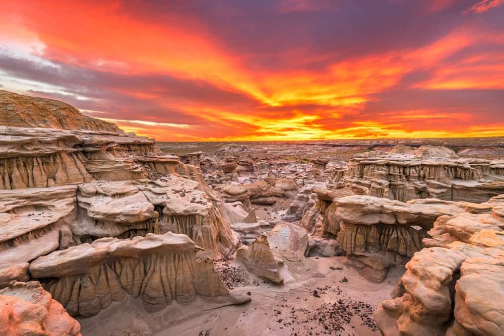 A hiker exploring the surreal landscape of the Bisti Badlands in New Mexico