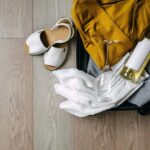 Suitcase containing clothes, wine, and sandals, illustrating vacation packing