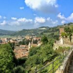 View of Canelli, a town in the Piedmont region of Italy with greenery, old buildings and blue skies