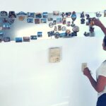 Magnets displayed on a large magnetic board in a kitchen, adding a colorful contrast to the room's decor.