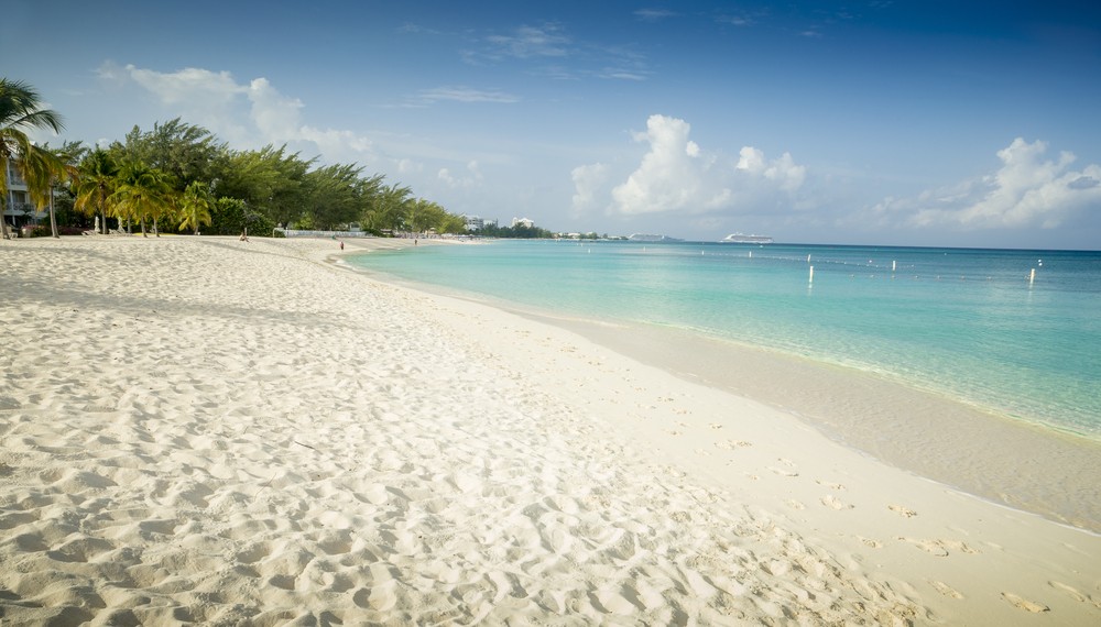 Beach view in the Cayman Islands showcasing clear turquoise waters and white sand