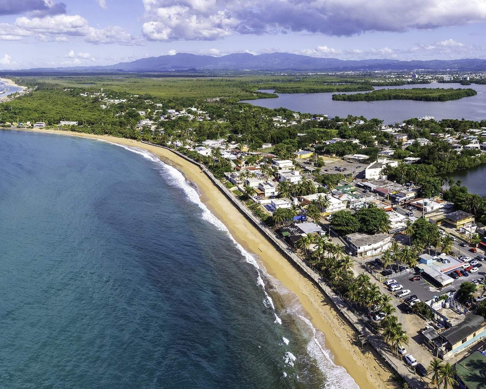 Aerial view of Caribbean beach and village, Puerto Rico, showcasing the beauty of Piñones Beach