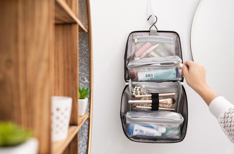Woman packing toiletry bag for air travel
