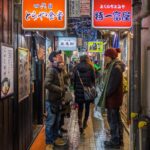Japanese street with vending machines and pedestrians