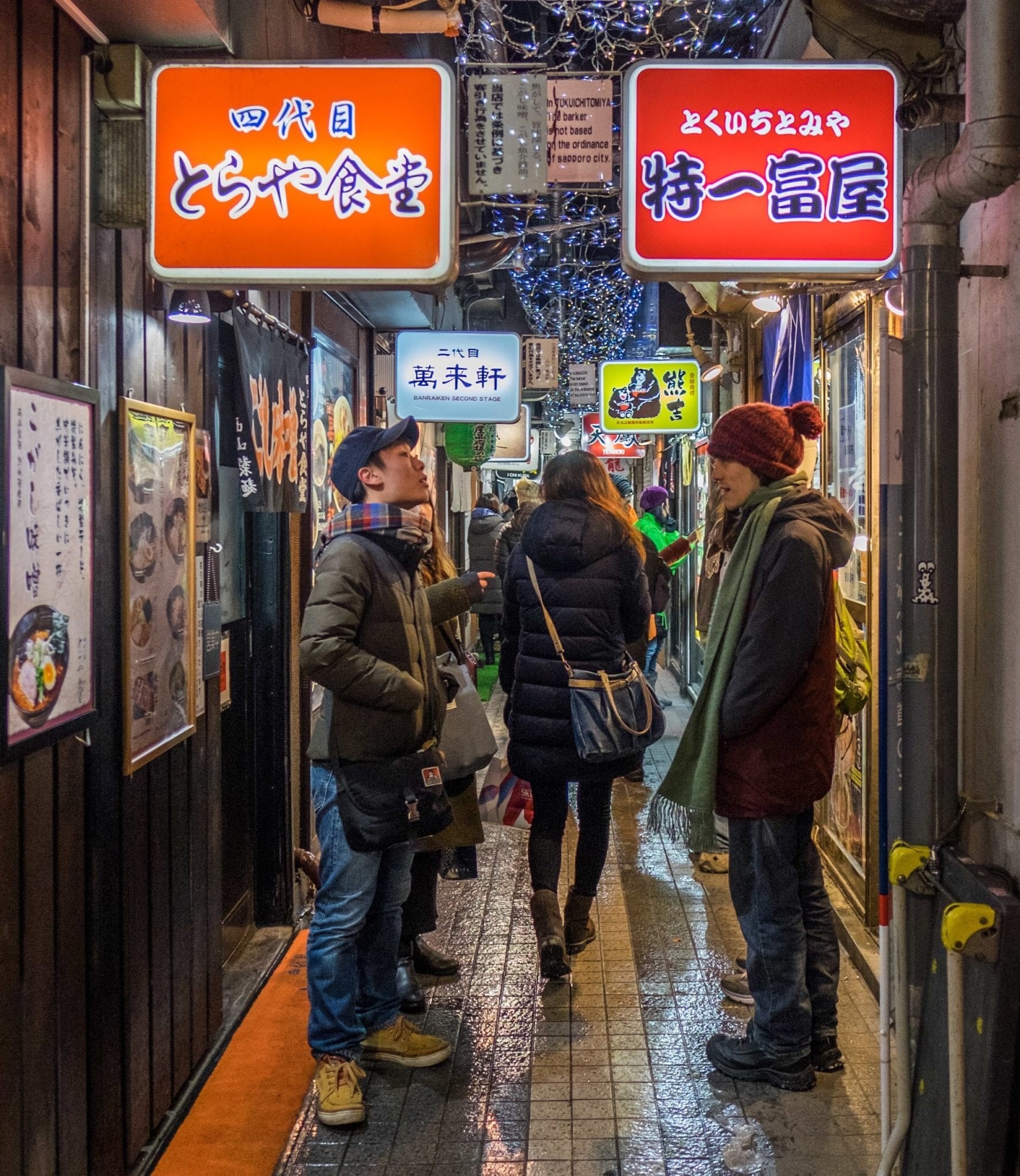 Japanese street with vending machines and pedestrians