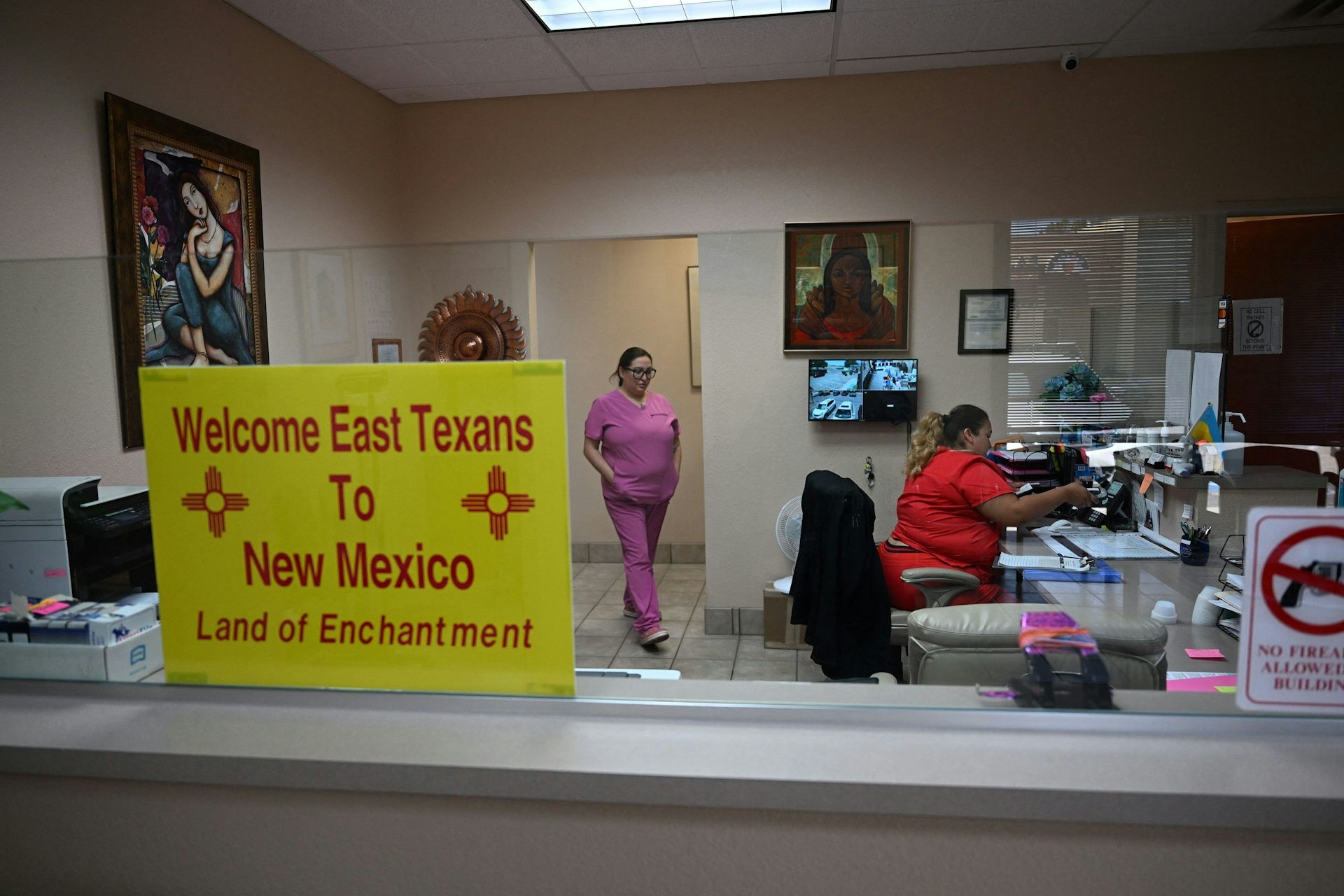 A sign welcoming patients from East Texas is displayed in the waiting area of a women’s reproductive health clinic in Santa Teresa, N.M., in June 2022.