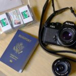 Camera, passport and film for travel.