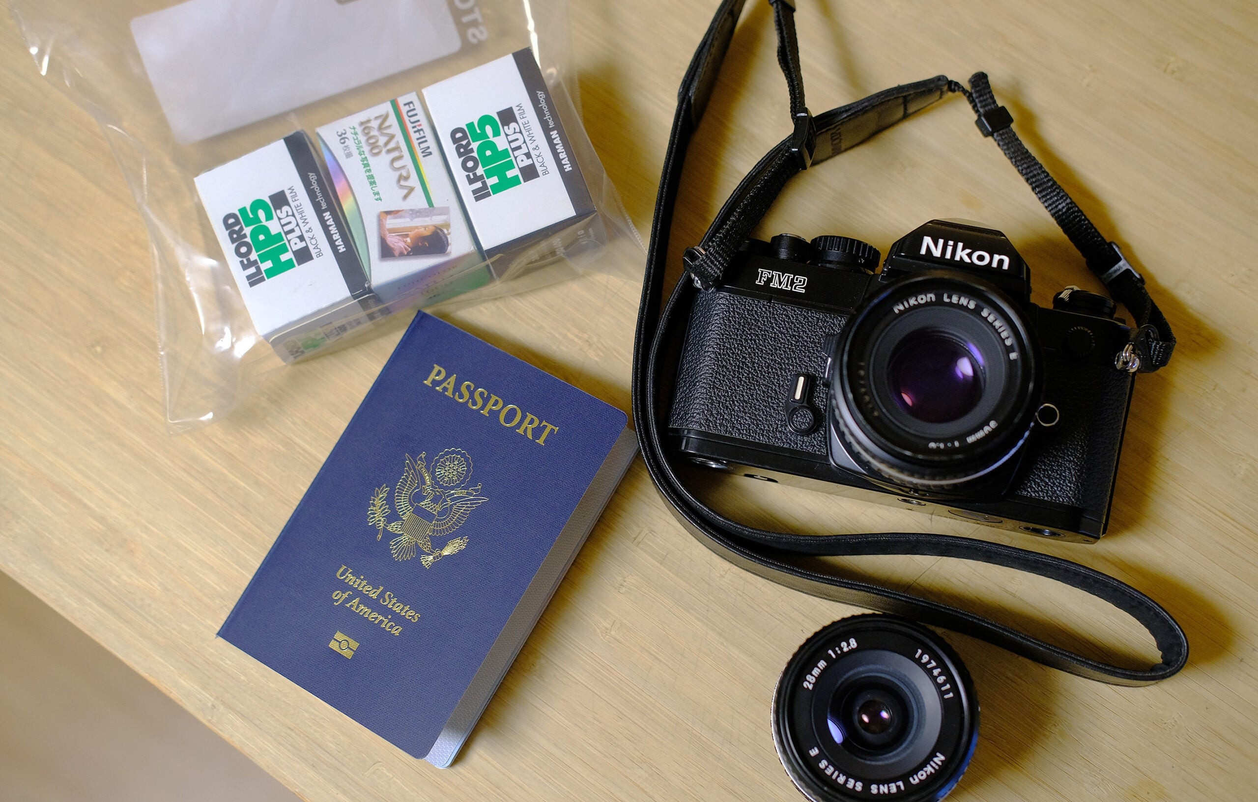 Camera, passport and film for travel.