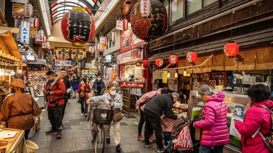 People browsing the bustling Kuromon Market in Osaka, exploring the wide array of food options