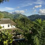Green mountains and a house nestled within them