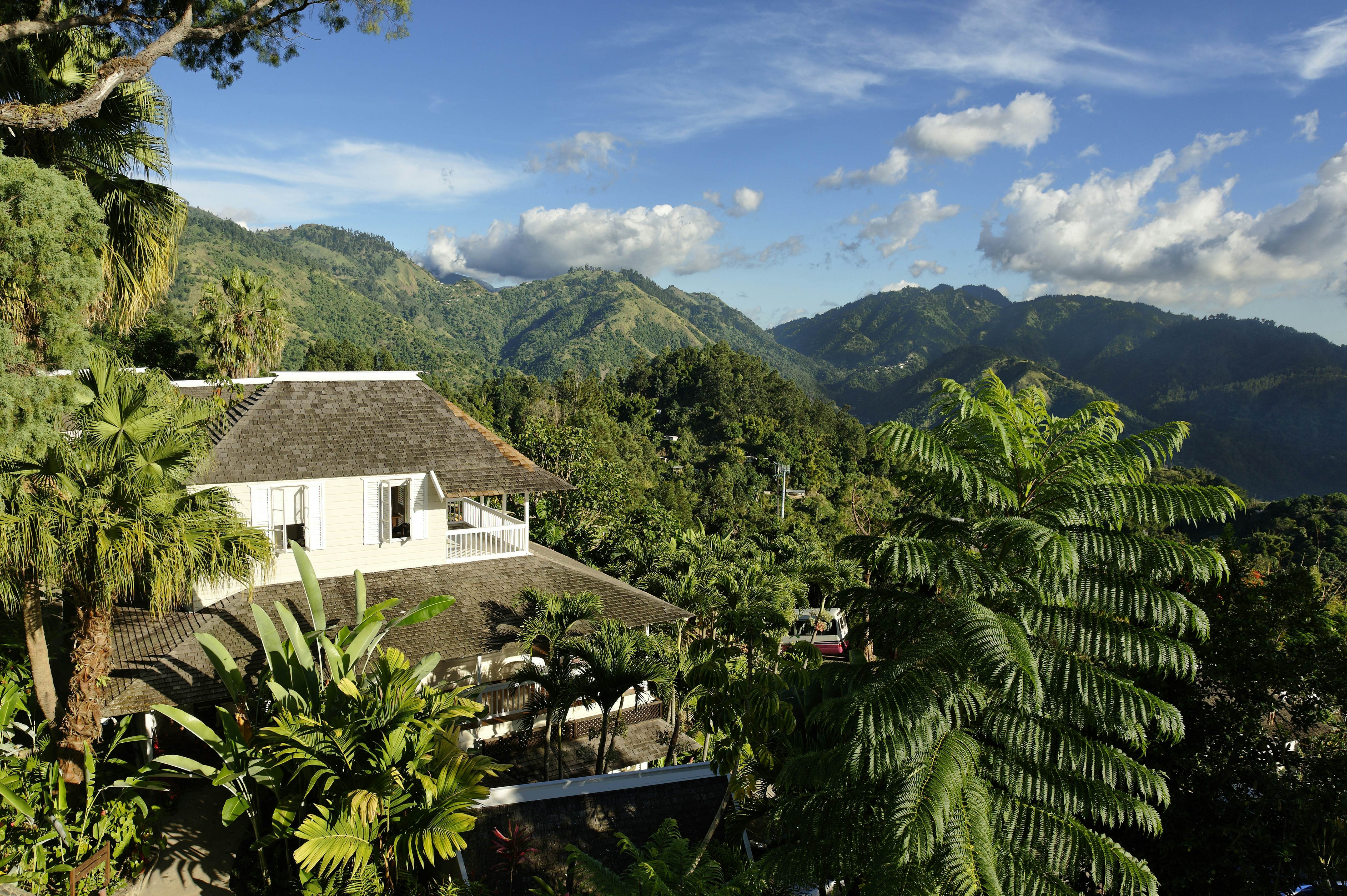 Green mountains and a house nestled within them