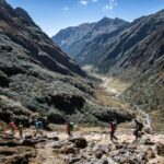 Trekers following a trail through a mountainous region