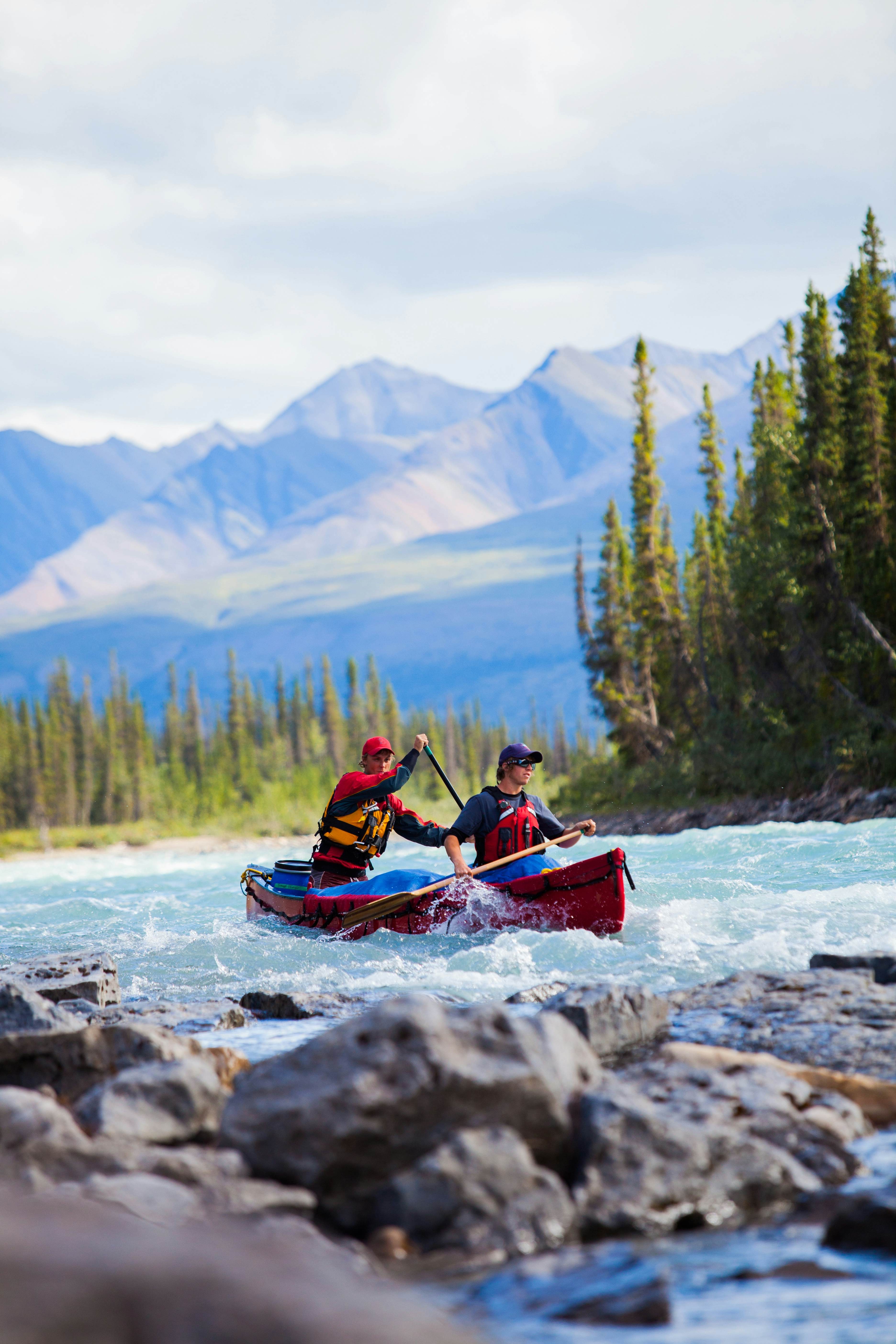 Rafting through the scenic Nahanni National Park Reserve in Canada, offering a unique blend of adventure and cultural immersion