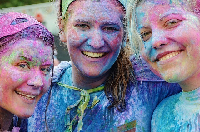 Happy people at the end of a color run representing networking