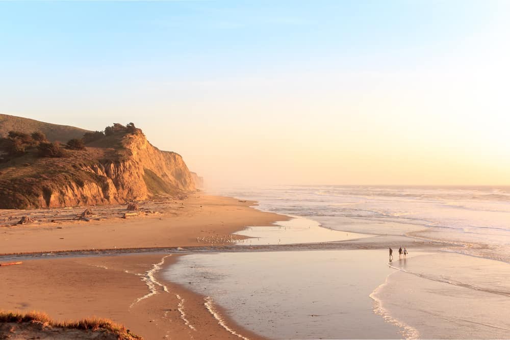 Half Moon Bay from above shows the coastal town nestled between the ocean and green hills, showcasing its scenic location.