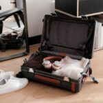 Carry-on suitcase filled packed with folded jumpers and headphones
