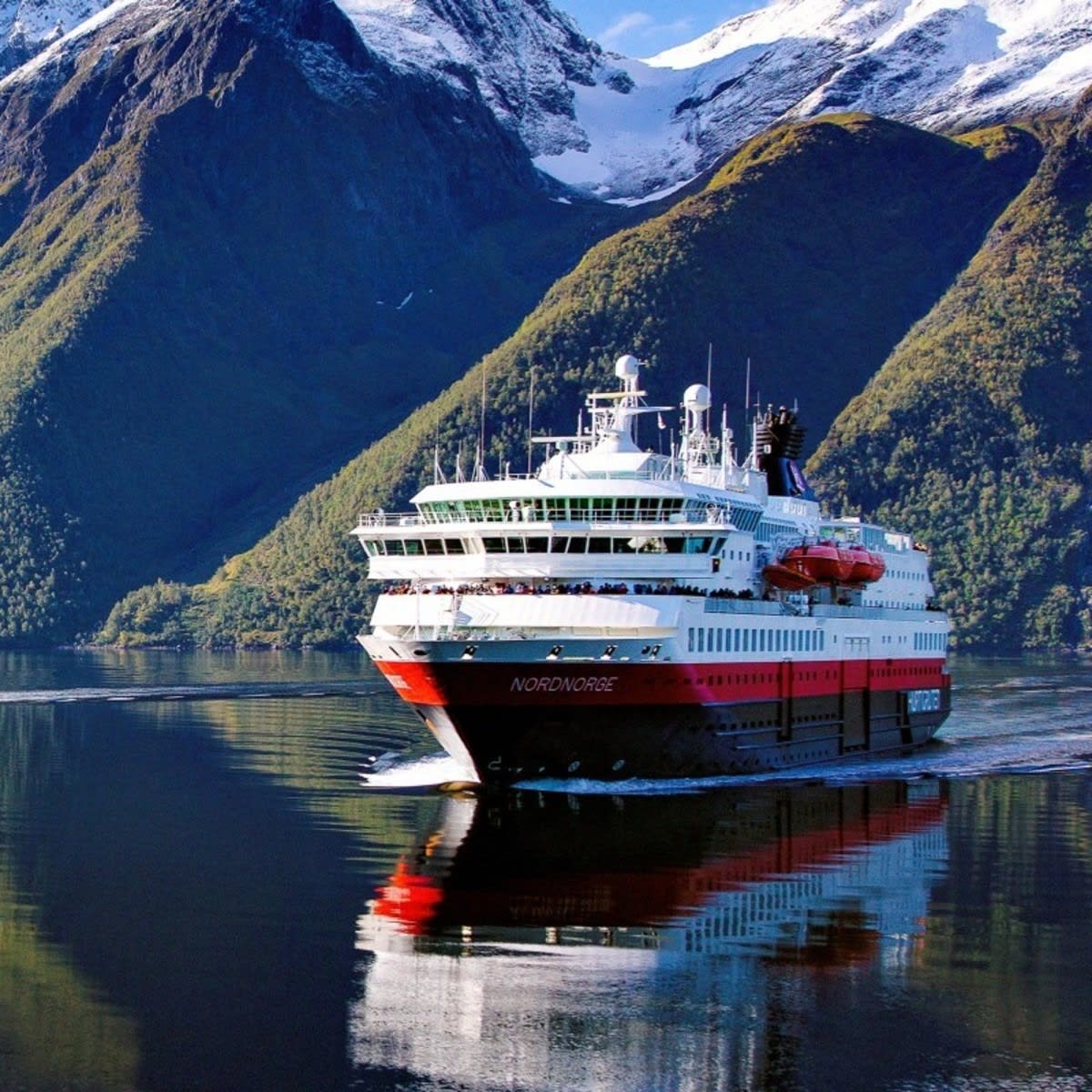 A red cruise ship at sea