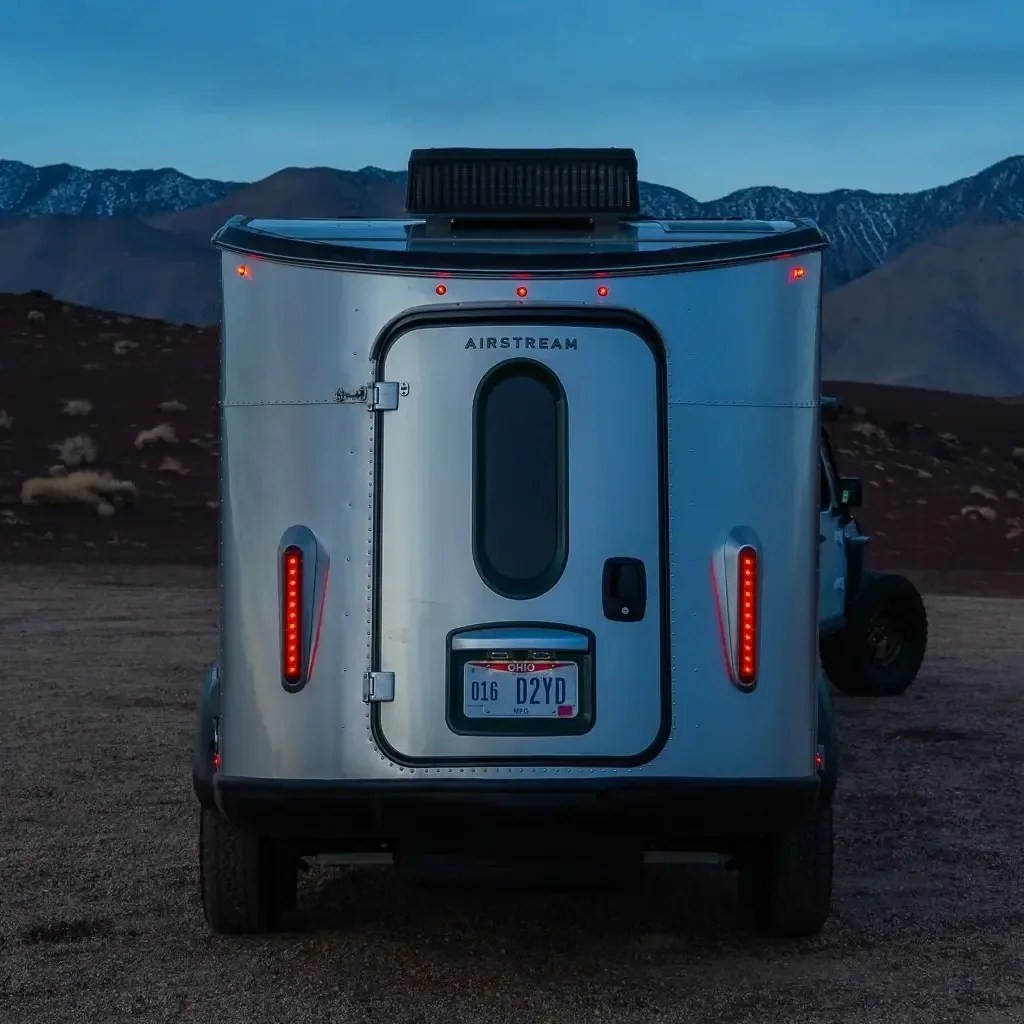 Airstream Basecamp trailer at night