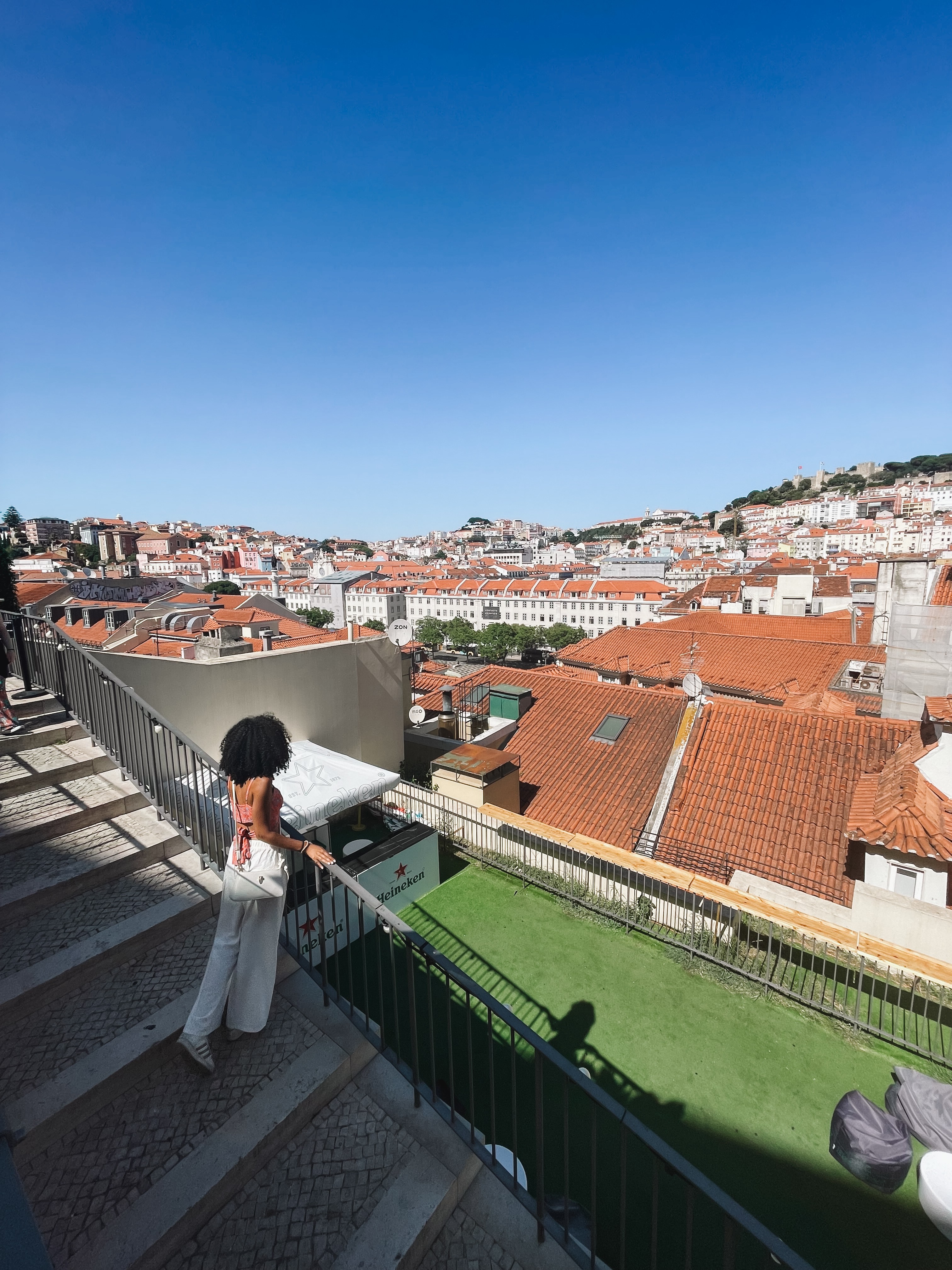 A solo female traveller enjoying a coffee at a Lisbon café, showcasing the city's relaxed atmosphere