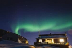 A close-up of Iqaluit, Nunavut, highlighting the traditional Inuit clothing and the serene winter setting.